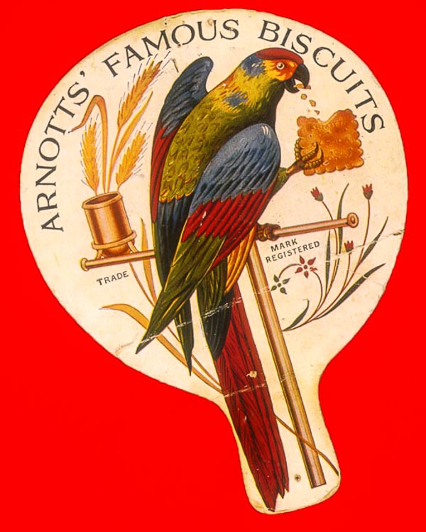 Arnotts Biscuits promotional cardboard fan. The  parrot was first registered in 1907 but legend has it that William Arnott was given a parrott by one of his customers soon after he opened his bakery in  Newcatle, NSW, in 1865. 