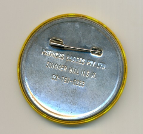 Back of badge showing the Patrick's address and telephone number which assists with dating 1980s1995.