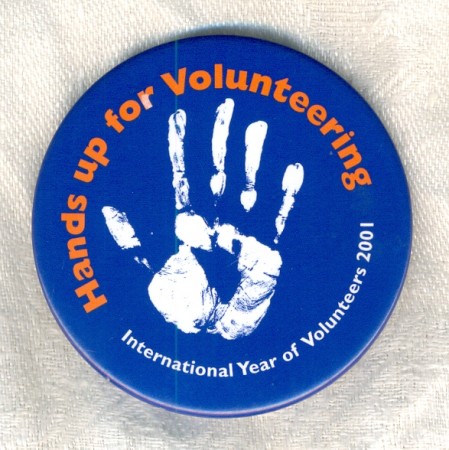 Hands up for volunteering, badge, 2001. Collection of Amanda Bede.